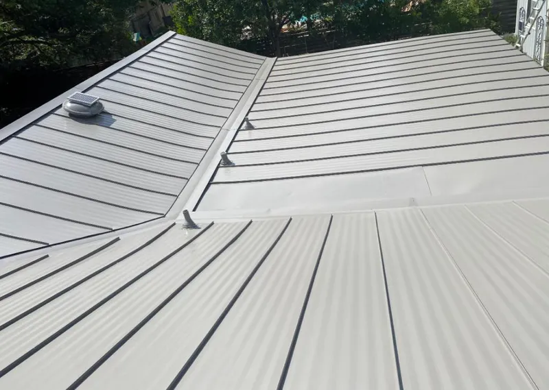 Solar attic fan installed on a metal roof for Roof Ventilation in Chaska
